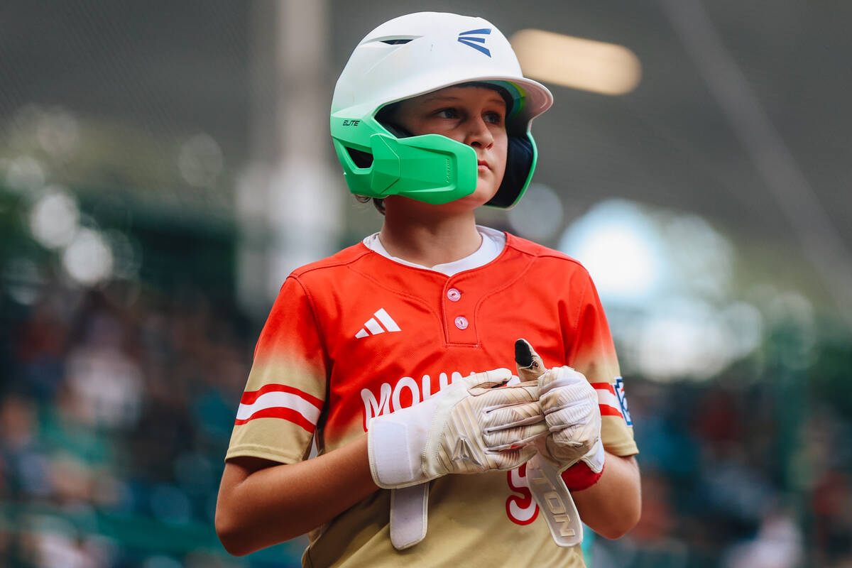 Summerlin South catcher Griffin Vargas takes off his gloves after batting during a Little Leagu ...