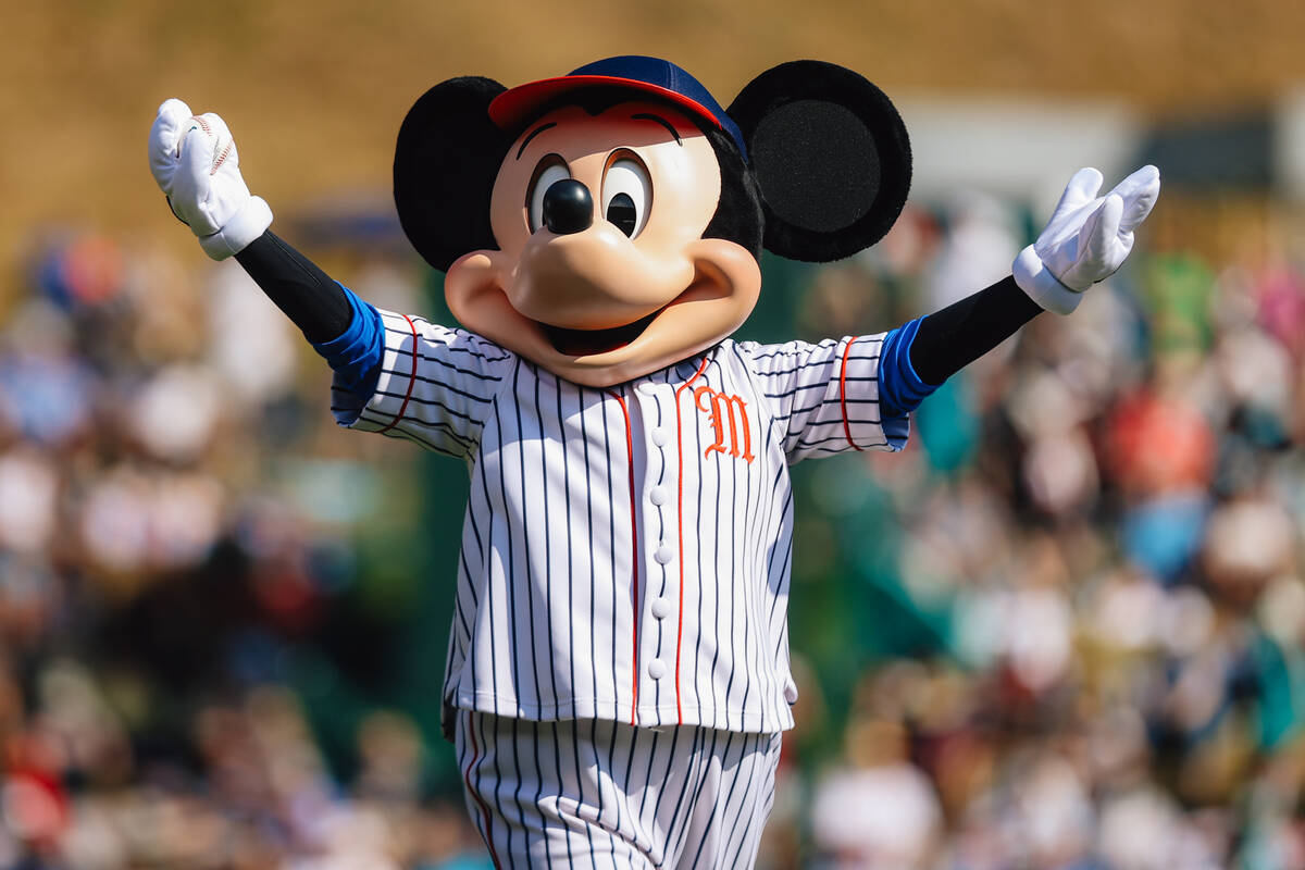 Mickey Mouse gets ready to throw the first pitch during a Little League World Series semifinals ...
