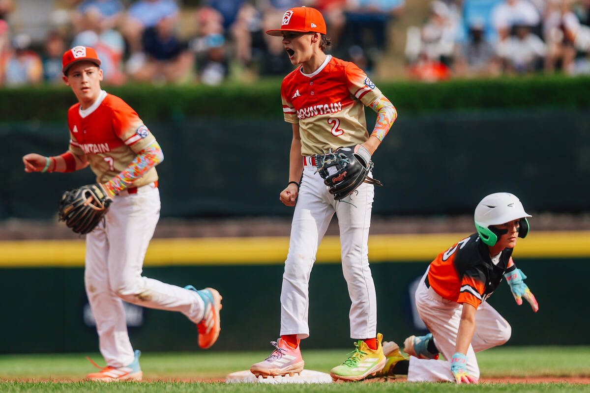 Summerlin South short stop Ethan Robertson (2) celebrates as Fairfield National second baseman ...