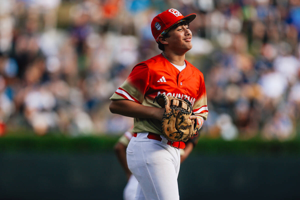 Summerlin South’s Grayson Miranda smiles as he takes to the field during a Little League ...