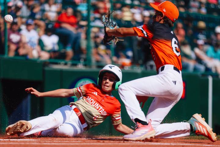 Summerlin South center fielder Brooks Fechser (4) slides to home base during a Little League W ...