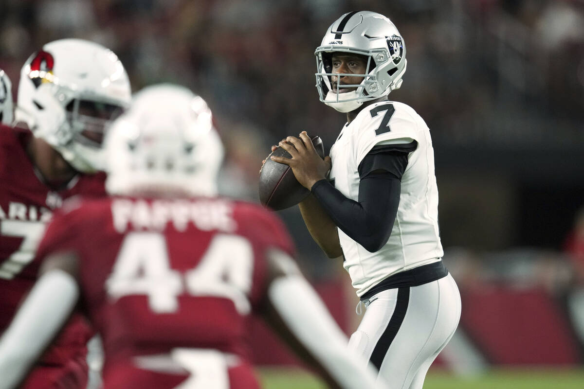 Las Vegas Raiders quarterback Geno Smith (7) looks to throw against the Arizona Cardinals durin ...