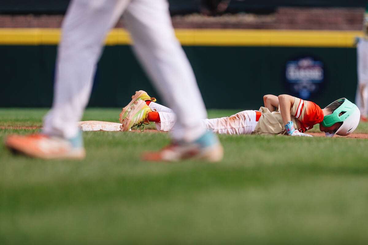 Summerlin South’s Luke D'Ambrosio takes a moment to lay on the ground by second base aft ...