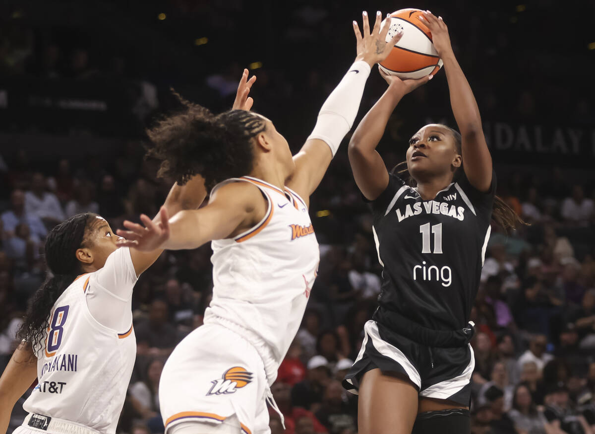 Aces guard Dana Evans (11) shoots against Phoenix Mercury forward Satou Sabally (0) during the ...