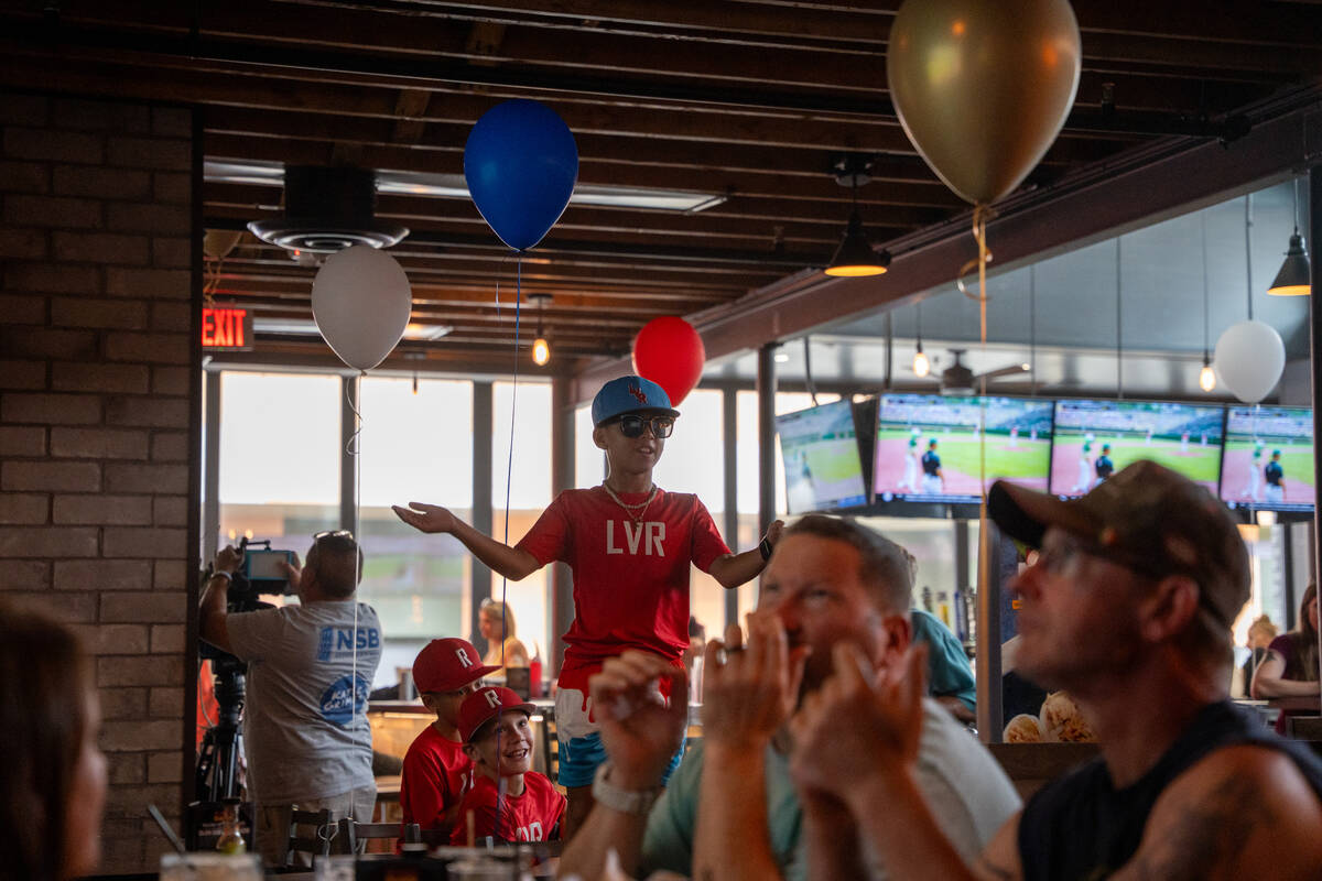 Giancarlo West stands on a chair to cheer on Summerlin South as they take on Taipei in the Litt ...