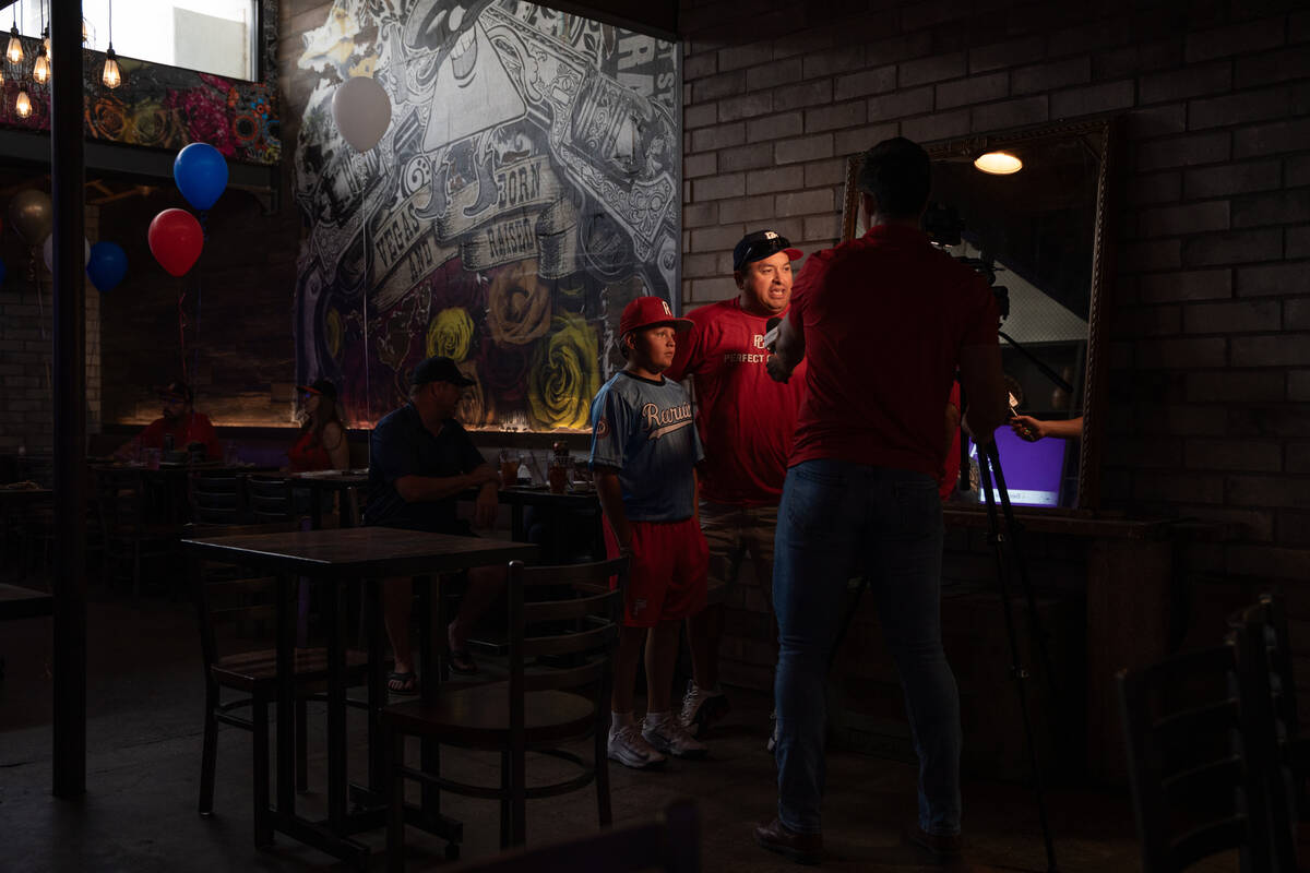 Media interview local Little League players and families during a watch party at Nacho Daddy in ...