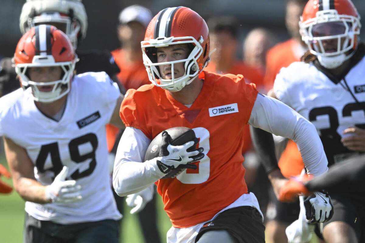 Cleveland Browns quarterback Kenny Pickett (8) runs with the ball during a practice at the team ...