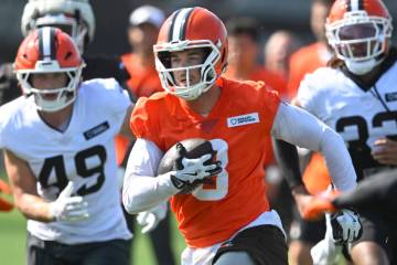 Cleveland Browns quarterback Kenny Pickett (8) runs with the ball during a practice at the team ...