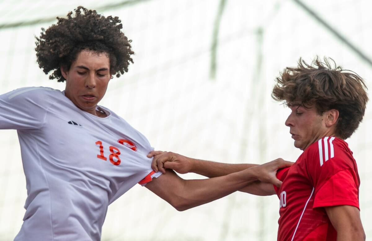 Bishop Gorman Eli Harris (18) and Coronado's Gavin Flickinger (11) compete for the ball during ...