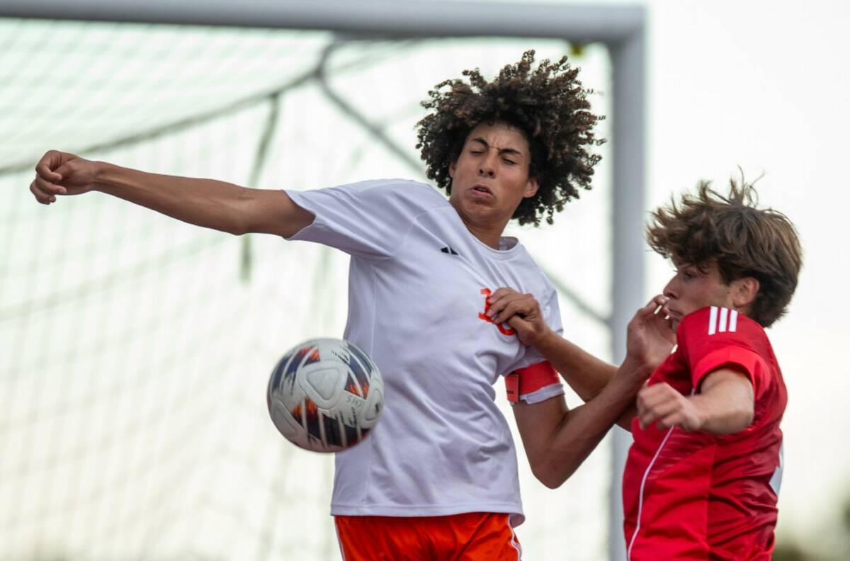Bishop Gorman's Eli Harris (18) and Coronado's Gavin Flickinger (11) compete for the ball durin ...
