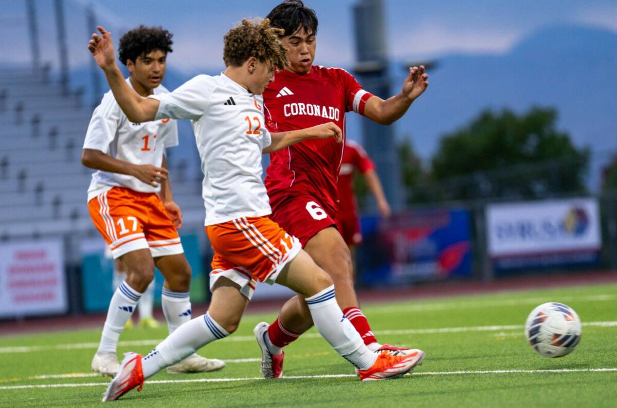 Bishop Gorman midfielder David Ensign (12) passes the ball during a soccer match between Corona ...