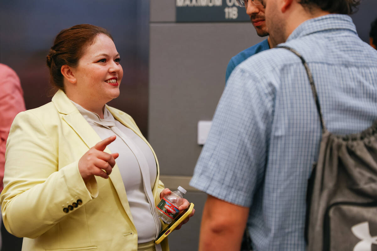 Olivia Tanager, Director of the Sierra Club Toiyabe Chapter, speaks with audience members after ...