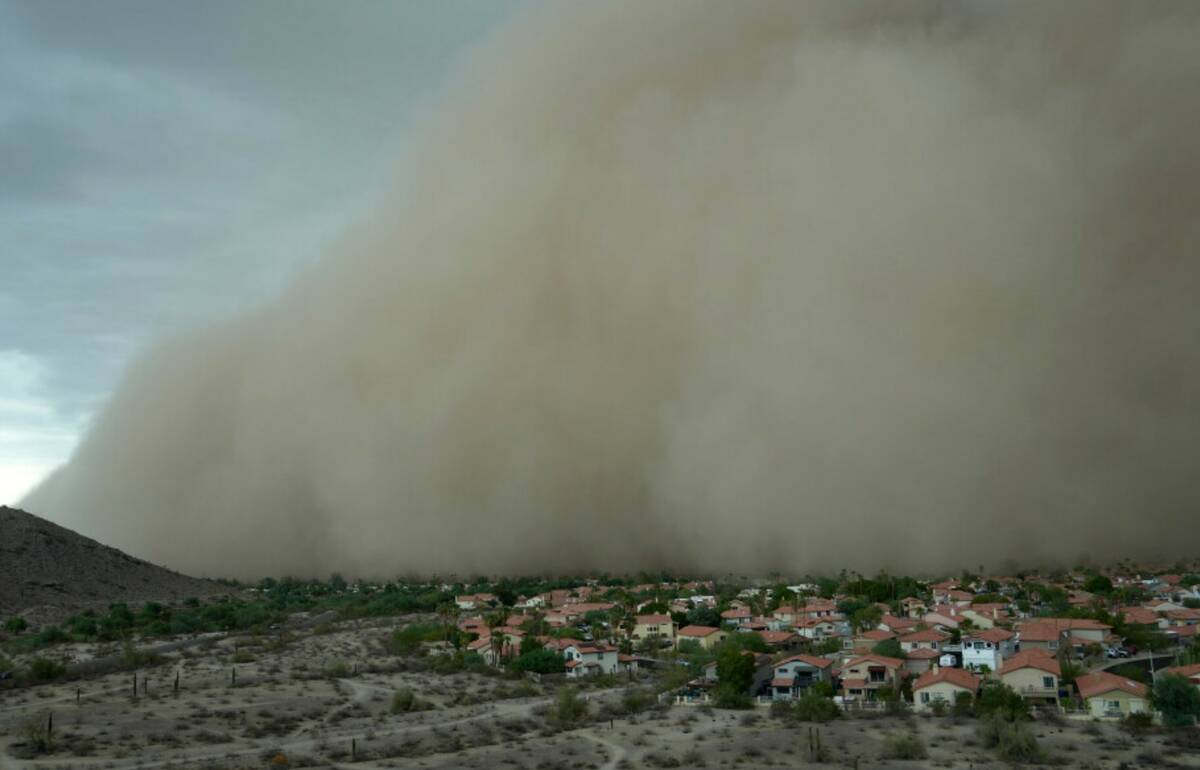 A giant dust storm approaches the Phoenix metro area as a monsoon storm pushes the dust into th ...