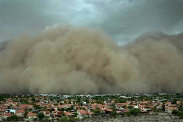 A giant dust storm approaches the Phoenix metro area as a monsoon storm pushes the dust into th ...