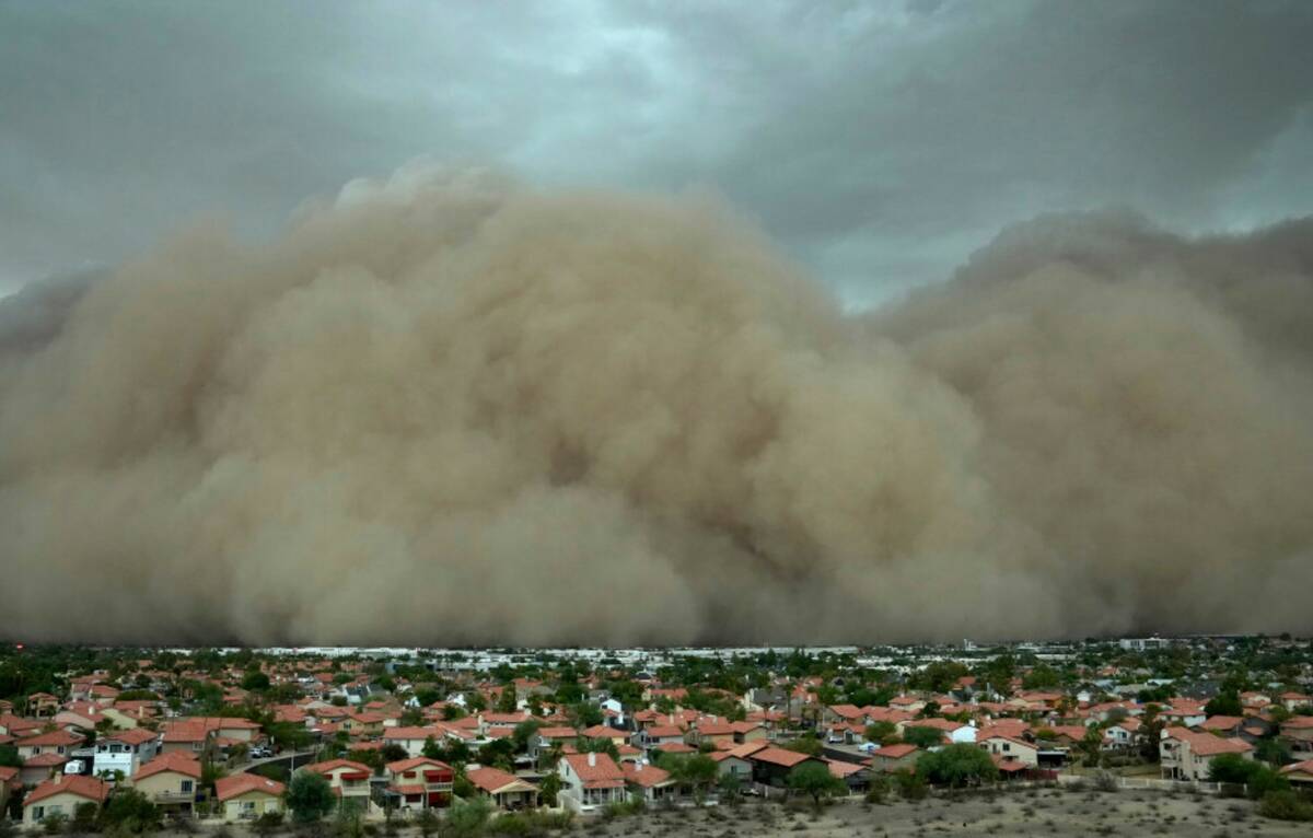 A giant dust storm approaches the Phoenix metro area as a monsoon storm pushes the dust into th ...