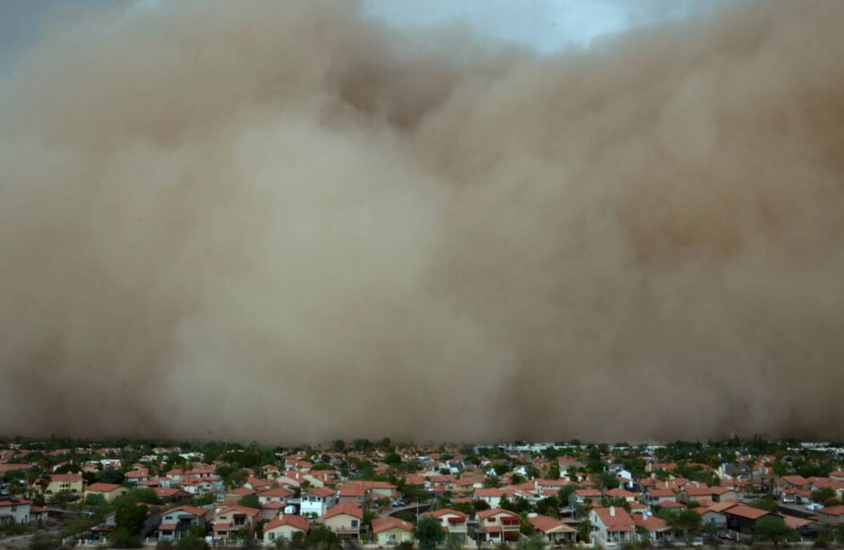 A giant dust storm approaches the Phoenix metro area as a monsoon storm pushes the dust into th ...