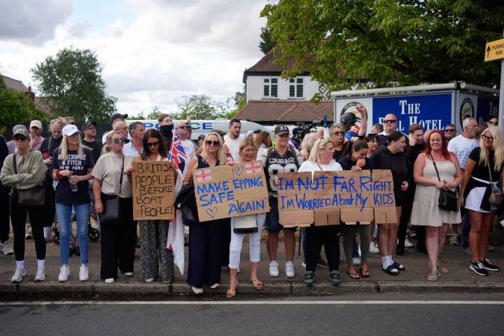 Protesters demonstrate outside the Bell Hotel in the town of Epping, Essex, England, Sunday, Ju ...