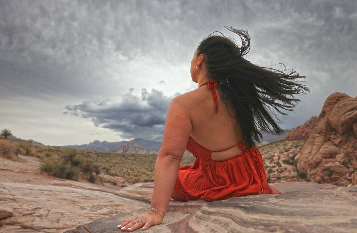 Torz Tumelty-Bevan, from Staffordshire, United Kingdom, watches as storms roll in to Red Rock C ...