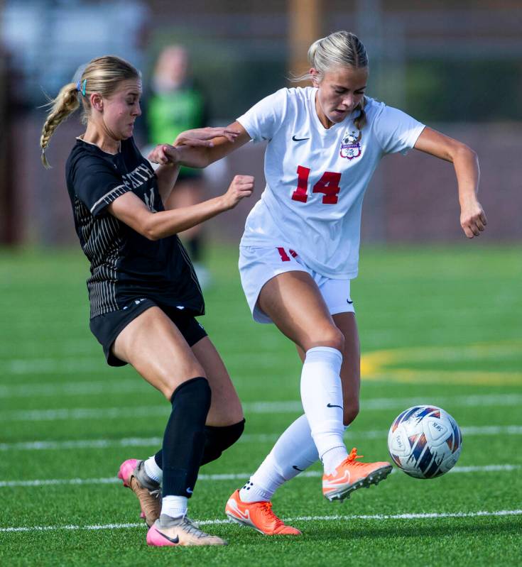 Faith Lutheran defender Kloe Abdalla (14) attempts to stay with Coronado midfielder Allison Kle ...