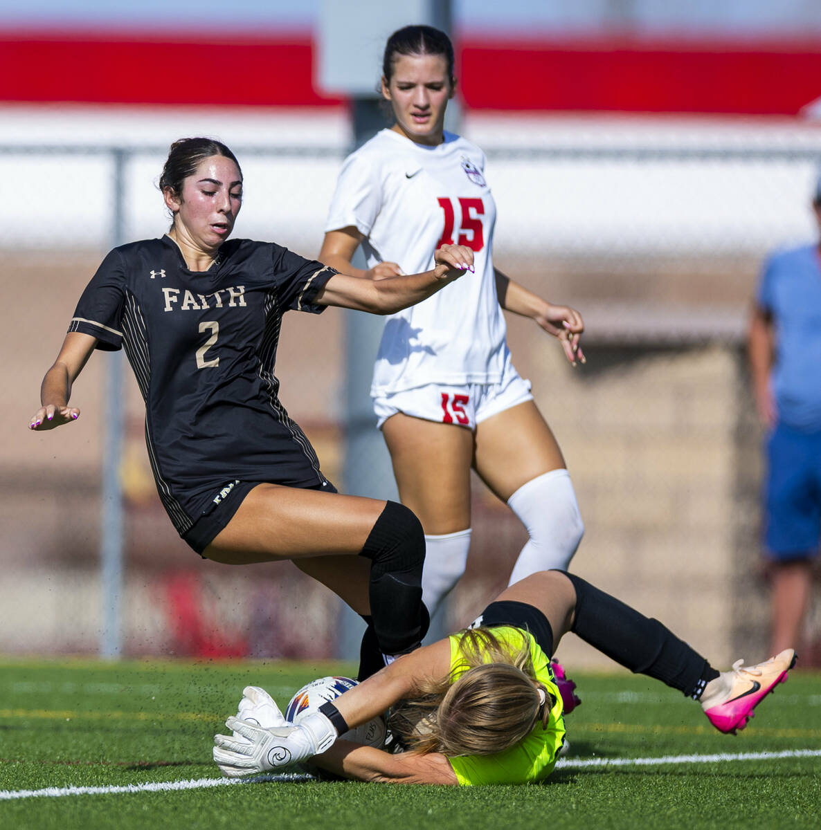 Faith Lutheran forward Elliott Lujan (2) has a shot smothered by Coronado goalkeeper Liliana Fo ...