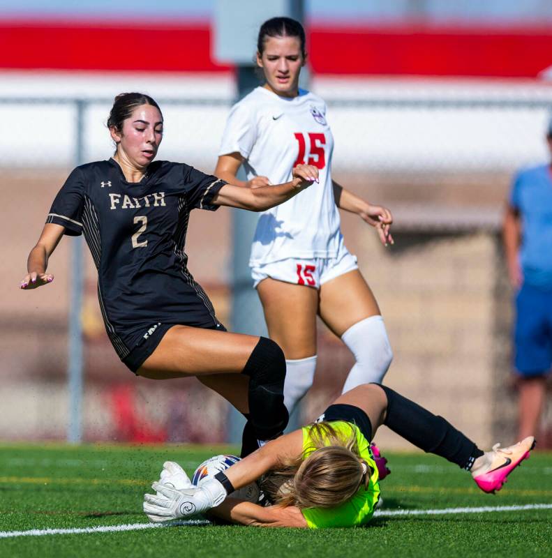 Faith Lutheran forward Elliott Lujan (2) has a shot smothered by Coronado goalkeeper Liliana Fo ...