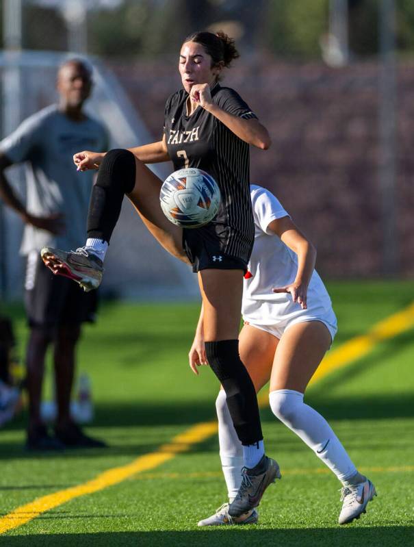 Coronado Faith Lutheran forward Elliott Lujan (2) secures the ball against Coronado defender El ...