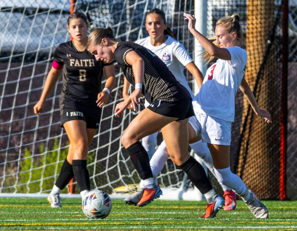 Faith Lutheran forward Allie Rabe (28) attempts to get the ball past Coronado midfielder Alexan ...