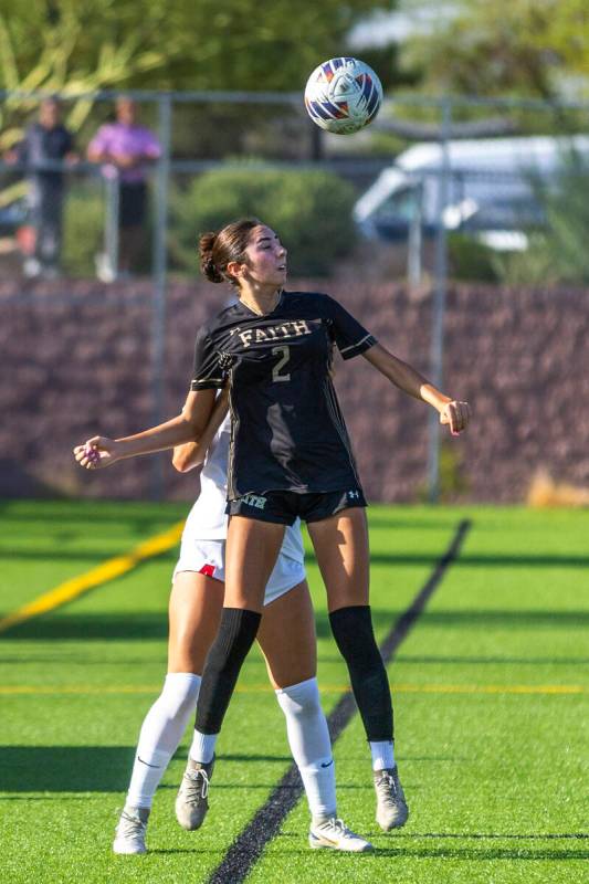 Coronado Faith Lutheran forward Elliott Lujan (2) heads the ball ahead of Coronado defender Ell ...