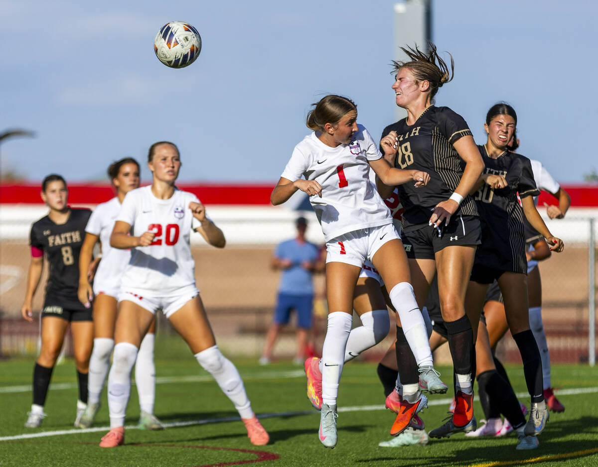 Faith Lutheran forward Allie Rabe (28) heads the ball away from Coronado midfielder Taytum Aren ...