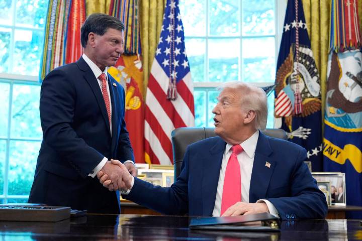 President Donald Trump, right, shakes the hand of Social Security Commissioner Frank Bisignano ...