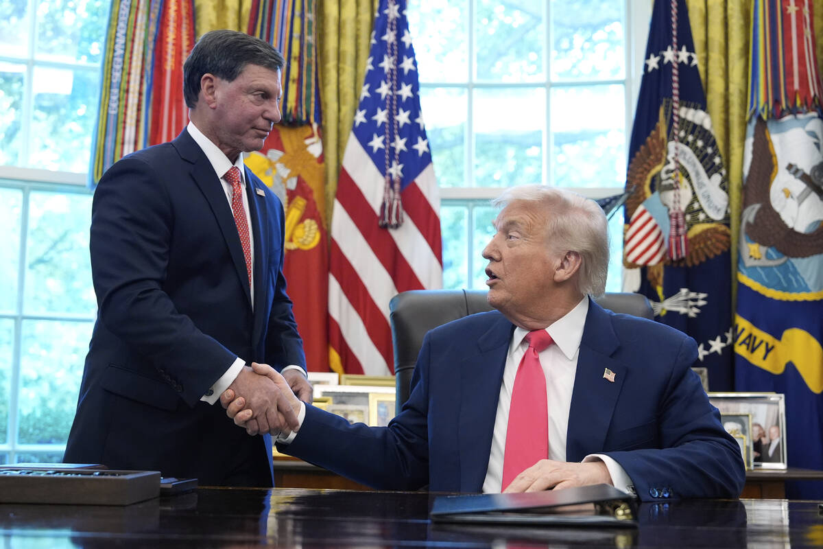 President Donald Trump, right, shakes the hand of Social Security Commissioner Frank Bisignano ...