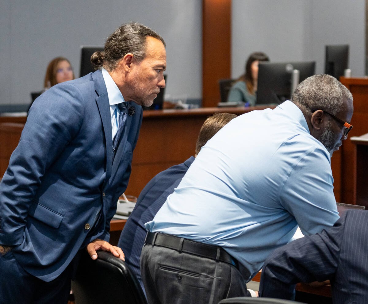 Nathan Williams and his defense attorney Michael Sanft look for an autopsy image Williams claim ...