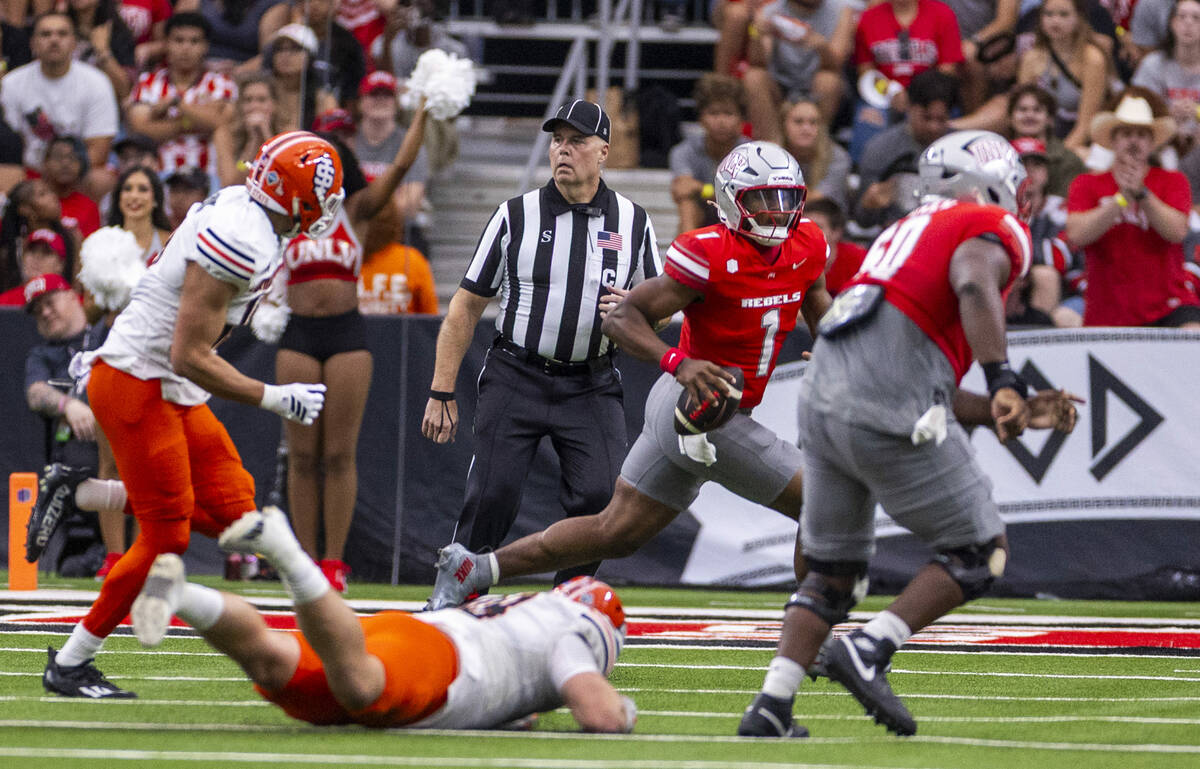 UNLV quarterback Alex Orji (1) looks for a receiver as he scrambles away from againstIdaho Stat ...