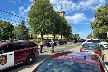 Law enforcement officers gather outside the Annunciation Church's school in response to a repor ...