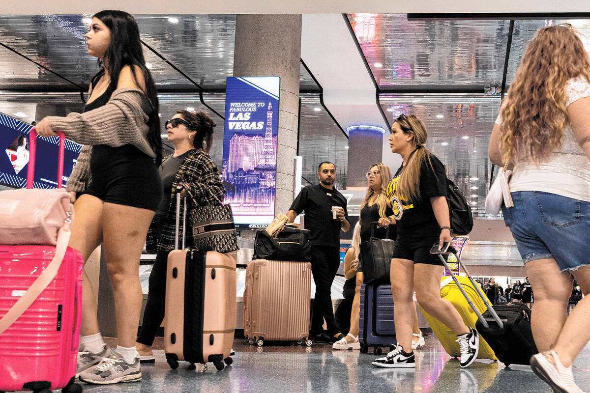 Arriving passengers head to baggage claim area at Terminal 1 of Harry Reid International Airpor ...