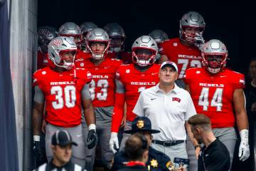 UNLV head coach Dan Mullen walks out of the tunnel with his team for the first half of their NC ...