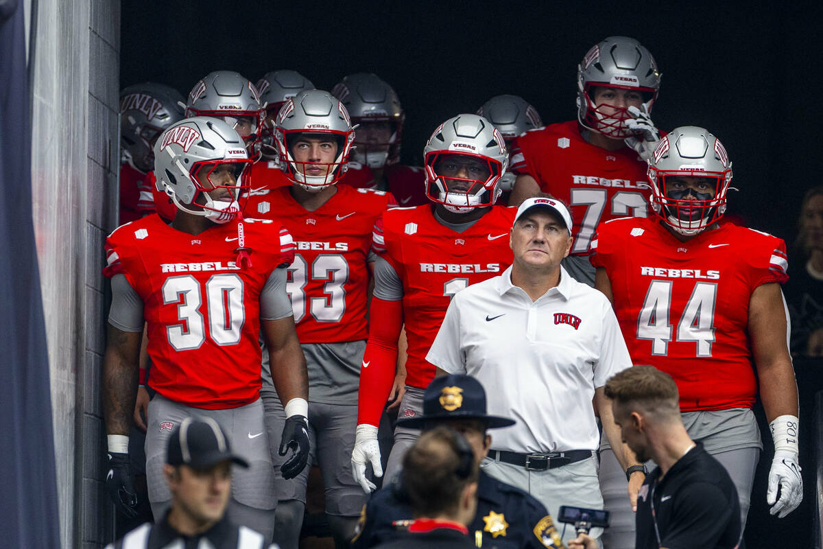 UNLV head coach Dan Mullen walks out of the tunnel with his team for the first half of their NC ...