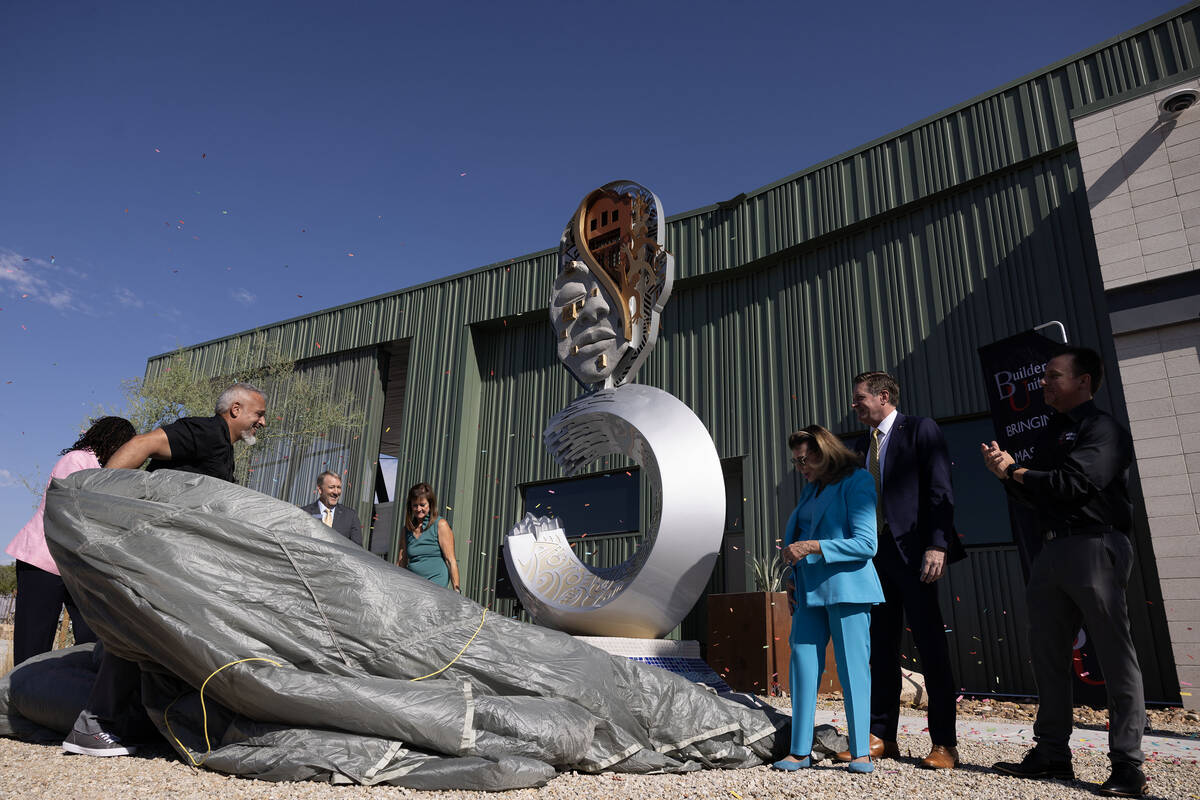 Artist Adolfo Gonzalez, left, unveils a sculpture he created as Mayor Shelley Berkley and Nevad ...