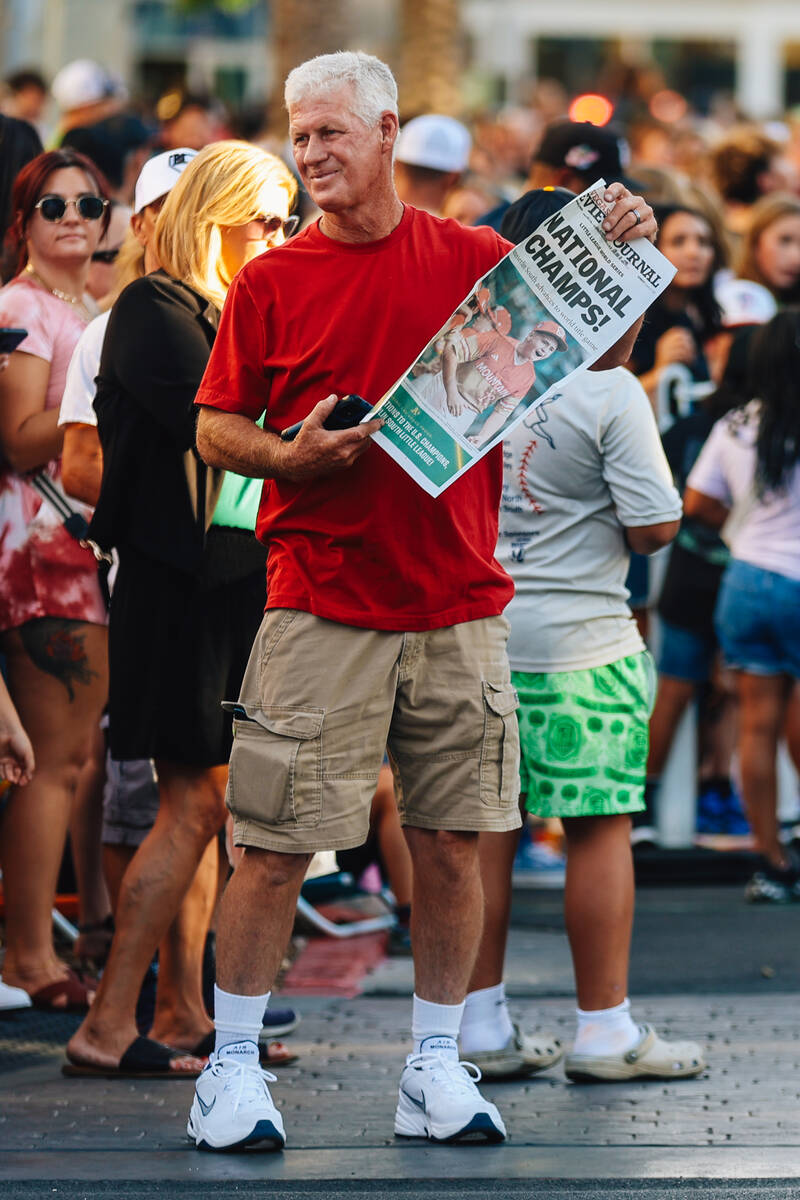 A parade attendee holds a copy of the Review-Journal during a parade in honor of Summerlin Sout ...