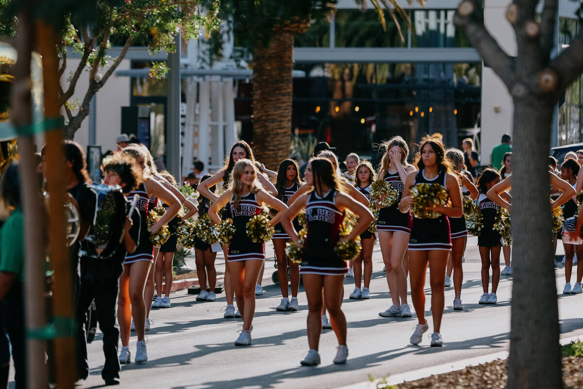 The Faith Lutheran High School cheerleading team stands in position before the parade celebrati ...