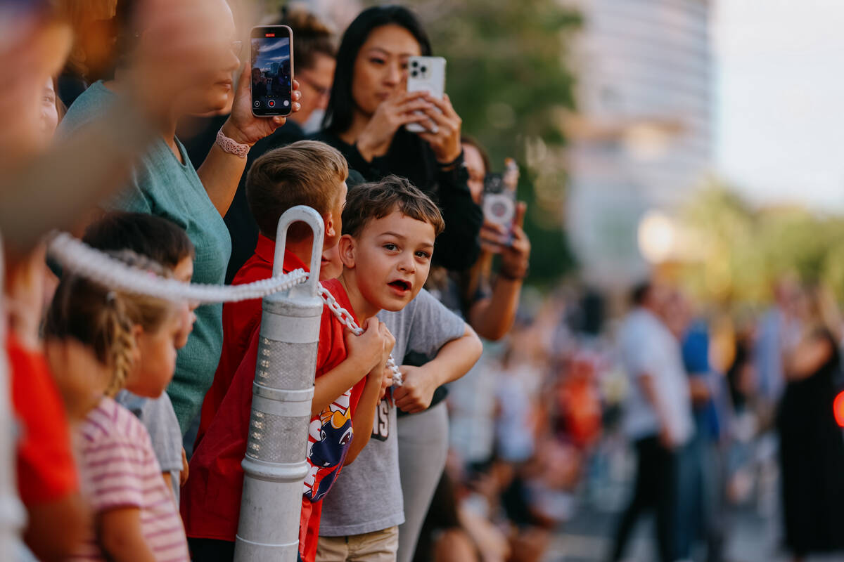 The crowd watches participants process down the route during the parade celebrating Summerlin S ...