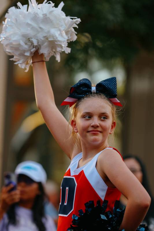 Cheerleaders from Doral Academy Red Rock walk down the street during the parade celebrating Sum ...