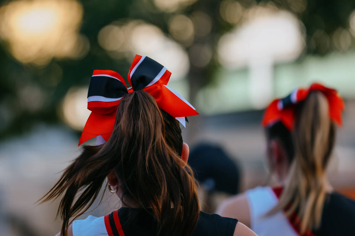 Cheerleaders from Doral Academy Red Rock walk down the street during the parade celebrating Sum ...