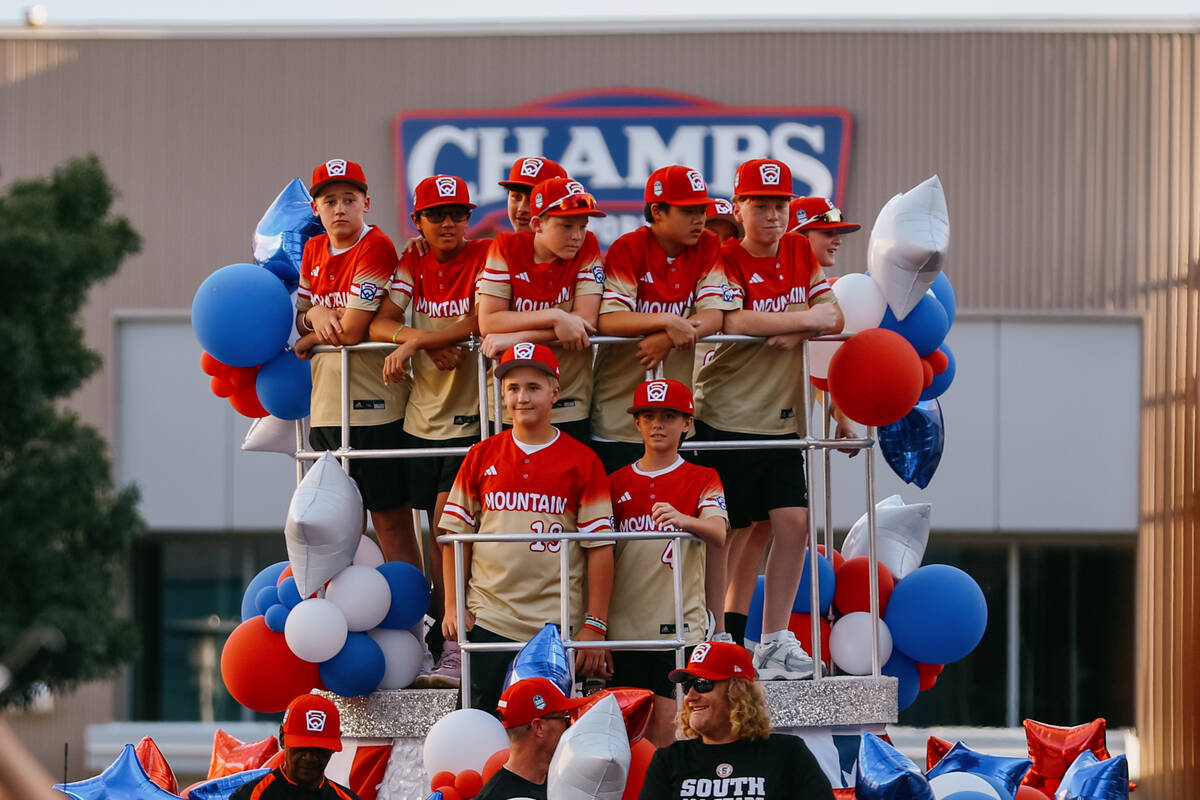 Members of the Summerlin South little league team stand on a float at the end of the parade cel ...