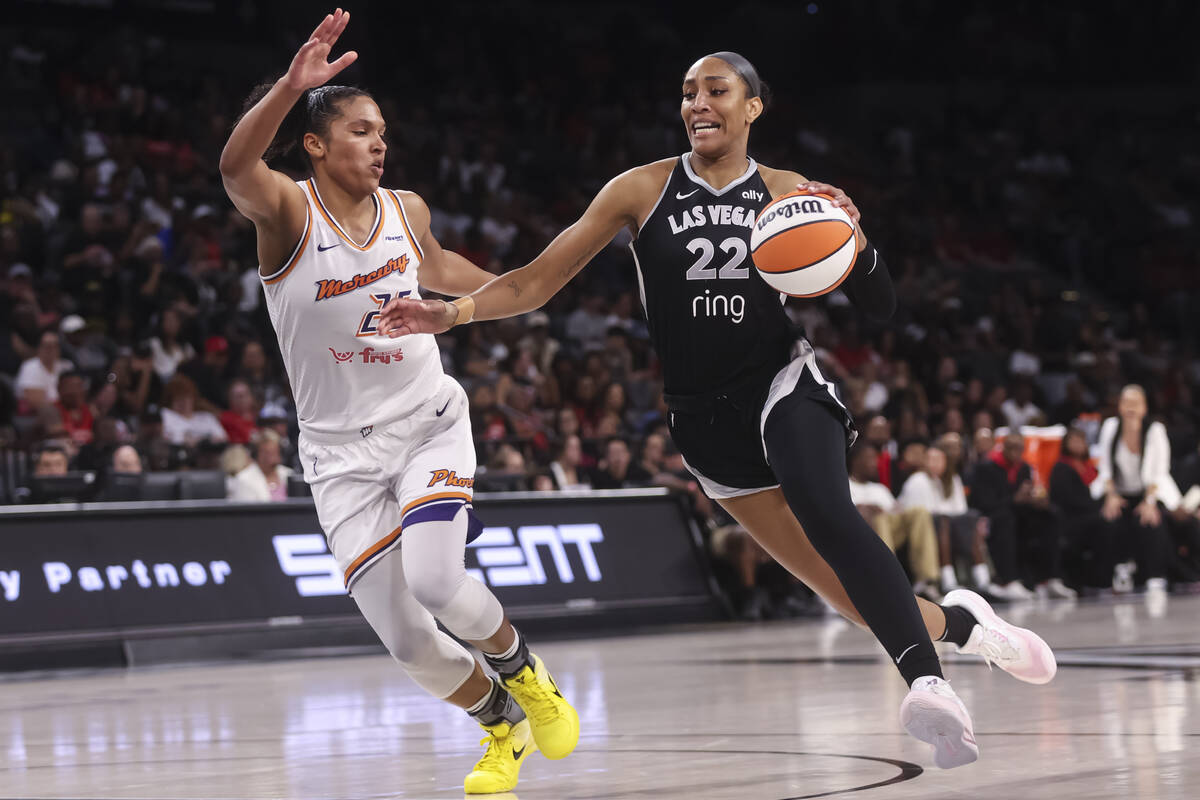 Aces center A'ja Wilson (22) drives to the basket against Phoenix Mercury forward Alyssa Thomas ...