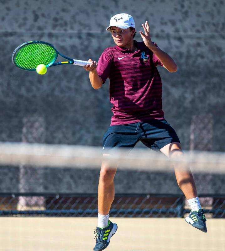 Faith Lutheran's Tyson Young returns a ball against Bishop Gorman during their NIAA tennis game ...
