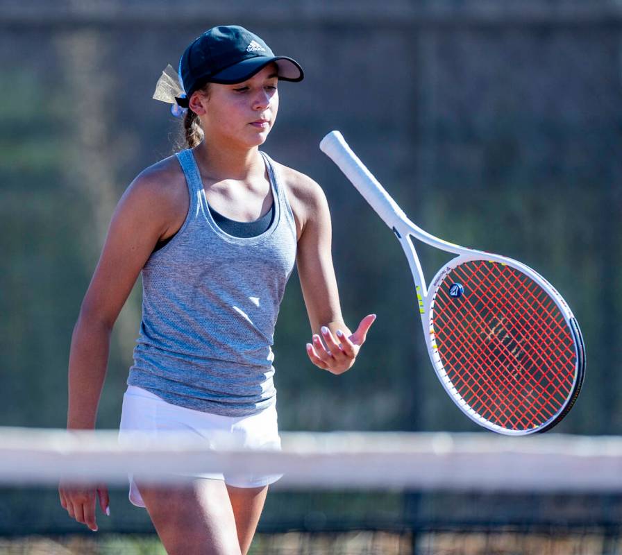 Bishop Gorman's Victoria Perez flips her racket as she changes sides against Faith Lutheran dur ...