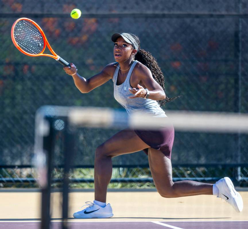 Faith Lutheran's Zoe Slushers tracks down a ball against Bishop Gorman during their singles NIA ...