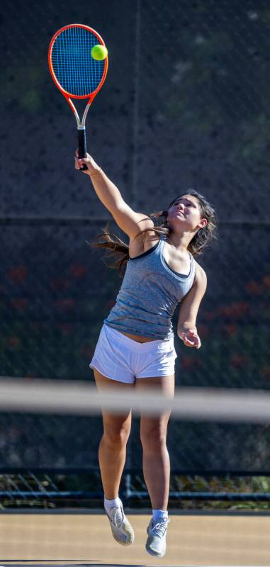 Bishop Gorman's Sophia Michaels serves a ball against Faith Lutheran during their doubles NIAA ...