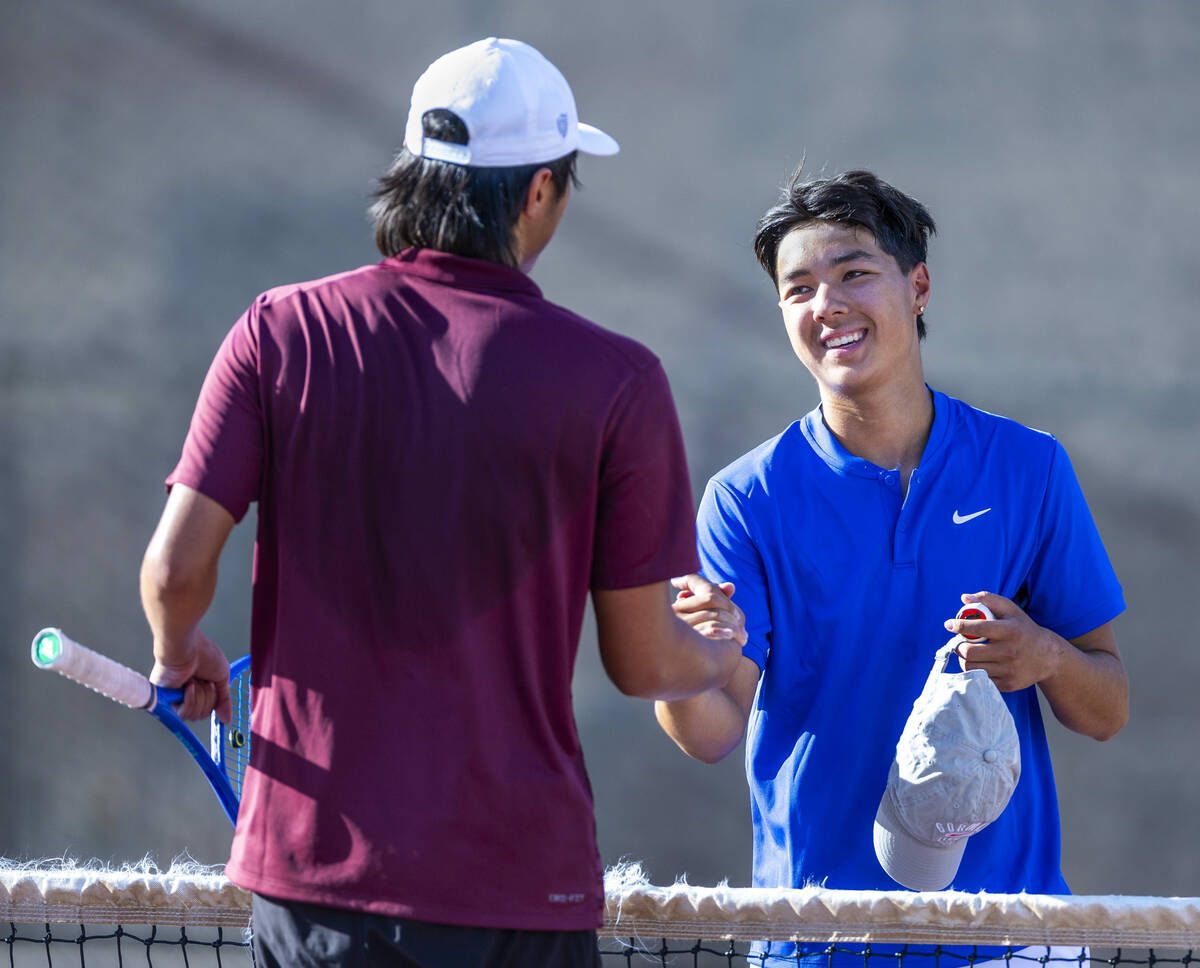 Faith Lutheran's Alpha Vonxaiburana shakes hands with Bishop Gorman's Shawn DeMilliano followin ...